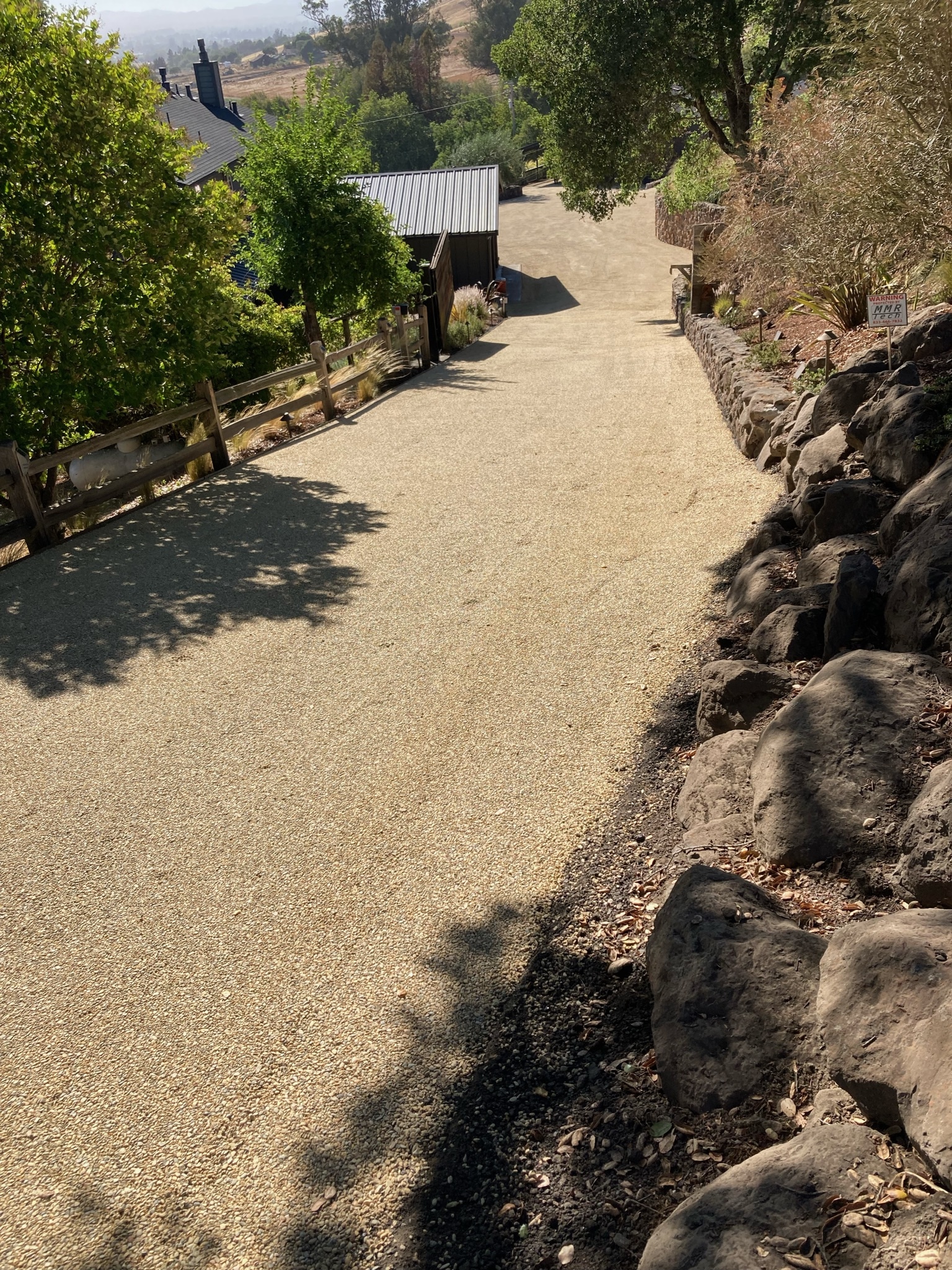 Chip seal driveway up to a hillside home